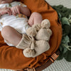 Soft hazelnut organic cotton knit baby booties designed to keep newborn feet warm and comfortable, featuring a timeless neutral colour for everyday wear or gifting.