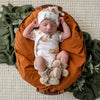 Soft hazelnut organic cotton knit baby booties designed to keep newborn feet warm and comfortable, featuring a timeless neutral colour for everyday wear or gifting.