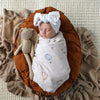 Soft Up & Away organic muslin wrap featuring a charming hot air balloon print, made from breathable organic cotton for swaddling, pram outings, feeding and everyday baby comfort.