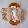 Soft cream organic cotton knit baby booties designed to keep newborn feet warm and comfortable, featuring a timeless neutral colour perfect for everyday wear or gifting.
