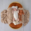 Soft cream organic cotton knit baby booties designed to keep newborn feet warm and comfortable, featuring a timeless neutral colour perfect for everyday wear or gifting.