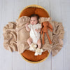 Soft cream organic cotton knit baby booties designed to keep newborn feet warm and comfortable, featuring a timeless neutral colour perfect for everyday wear or gifting.