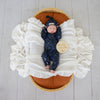Baby wearing the Starry Night organic cotton convertible romper with fold-over feet and mittens, featuring a soft star print for comfortable day and night wear.