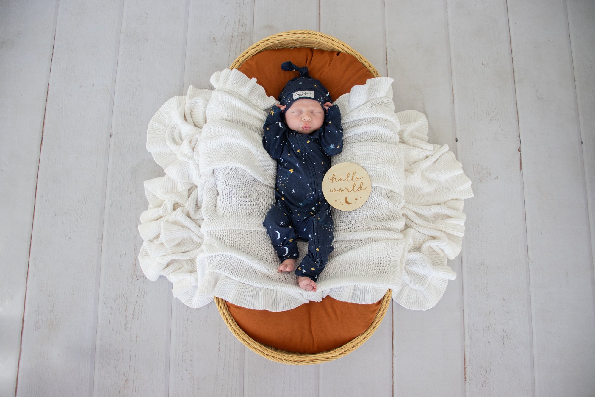 Baby wearing the Starry Night organic cotton convertible romper with fold-over feet and mittens, featuring a soft star print for comfortable day and night wear.