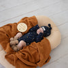 Soft hazelnut organic cotton knit baby booties designed to keep newborn feet warm and comfortable, featuring a timeless neutral colour for everyday wear or gifting.