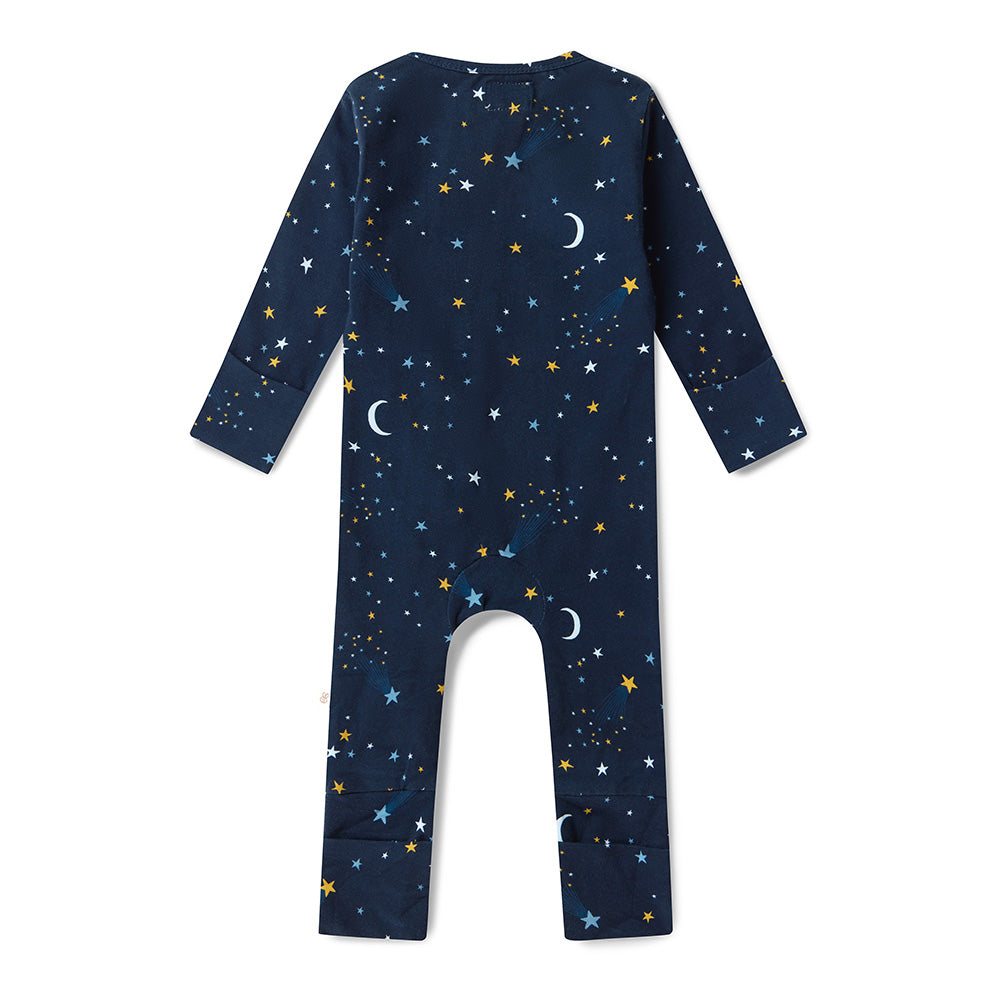 Baby wearing the Starry Night organic cotton convertible romper with fold-over feet and mittens, featuring a soft star print for comfortable day and night wear.
