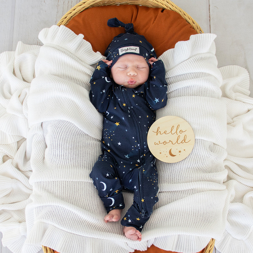 Baby wearing the Starry Night organic cotton convertible romper with fold-over feet and mittens, featuring a soft star print for comfortable day and night wear.