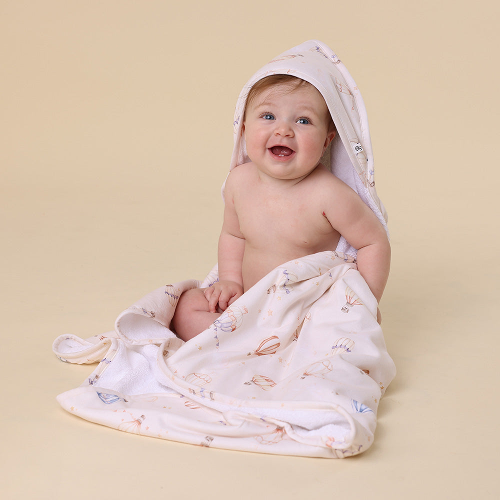 Soft Up & Away organic hooded baby towel made from absorbent organic cotton with a sweet hot air balloon print, perfect for newborn bath time and keeping babies warm after bathing.