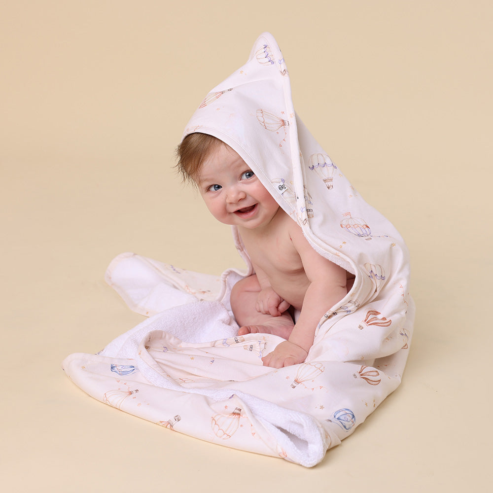 Soft Up & Away organic hooded baby towel made from absorbent organic cotton with a sweet hot air balloon print, perfect for newborn bath time and keeping babies warm after bathing.