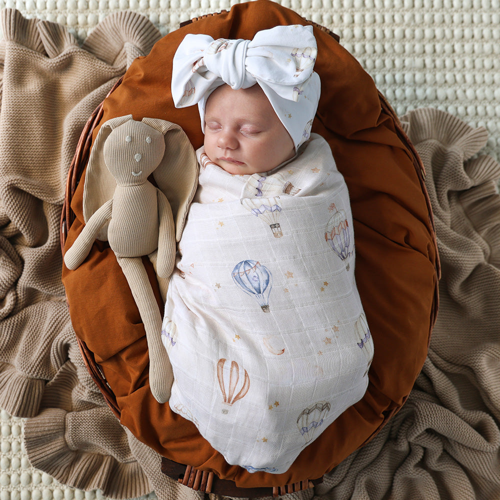 Soft Up & Away organic muslin wrap featuring a charming hot air balloon print, made from breathable organic cotton for swaddling, pram outings, feeding and everyday baby comfort.