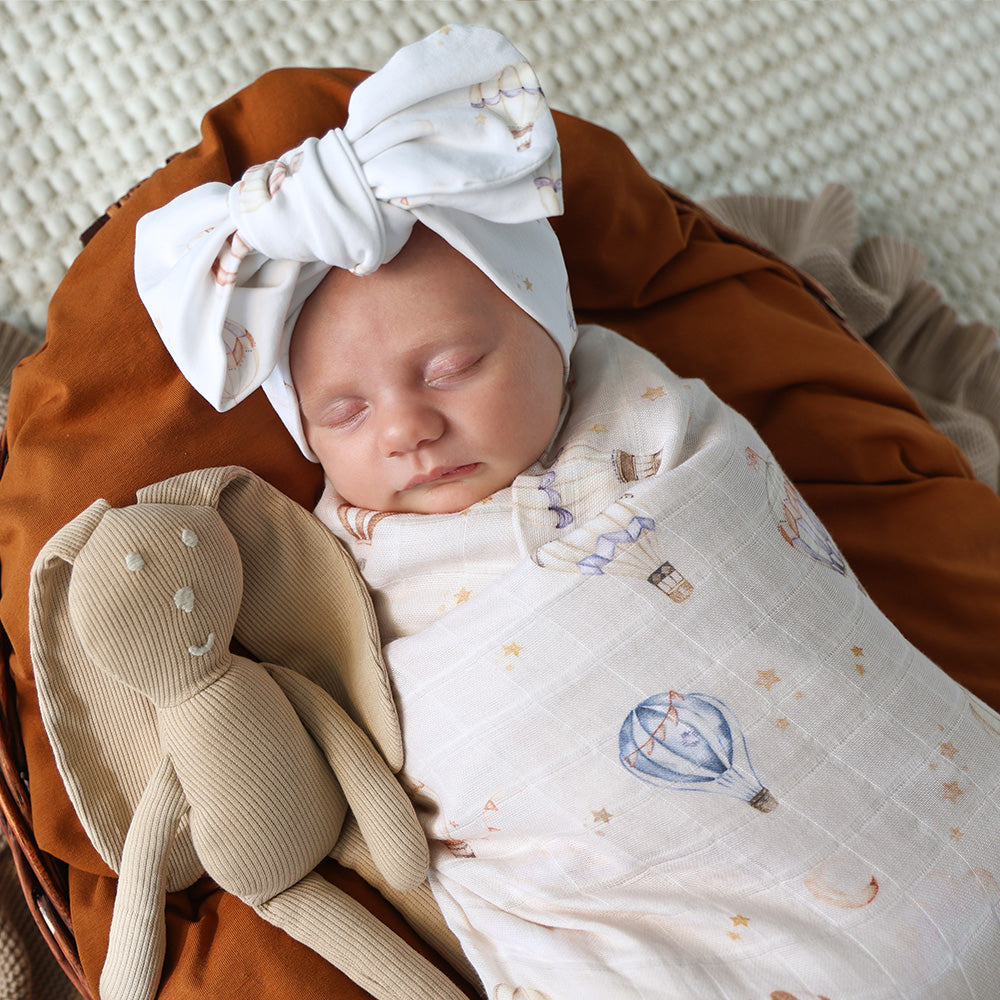 Soft Up & Away organic muslin wrap featuring a charming hot air balloon print, made from breathable organic cotton for swaddling, pram outings, feeding and everyday baby comfort.