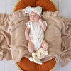 Soft cream organic cotton knit baby booties designed to keep newborn feet warm and comfortable, featuring a timeless neutral colour perfect for everyday wear or gifting.