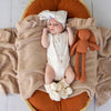 Soft cream organic cotton knit baby booties designed to keep newborn feet warm and comfortable, featuring a timeless neutral colour perfect for everyday wear or gifting.