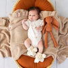 Soft cream organic cotton knit baby booties designed to keep newborn feet warm and comfortable, featuring a timeless neutral colour perfect for everyday wear or gifting.