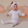 Baby wearing the Up & Away organic cotton zip footie with a hot air balloon print, featuring a two-way zip and enclosed feet for soft, comfortable day and night wear.